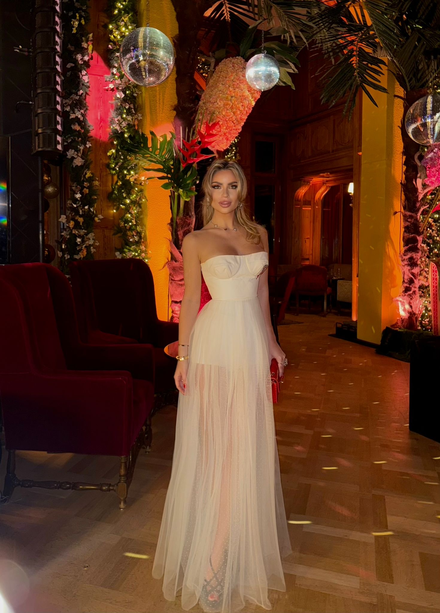 Bespoke cream strapless evening gown with a structured bodice and sheer pleated tulle skirt.
