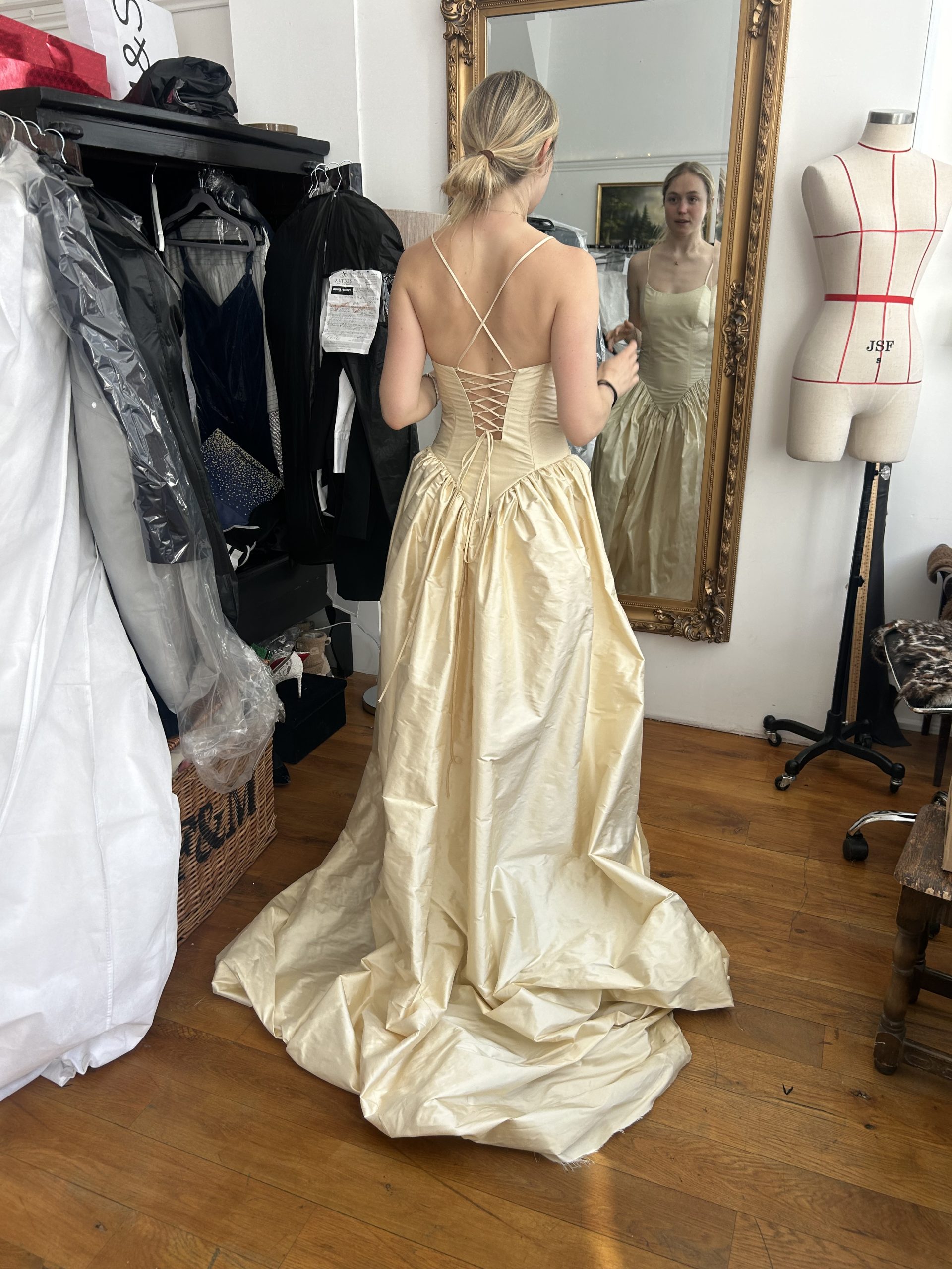 Champagne ball gown with lace-up back during a fitting in the Altbes atelier