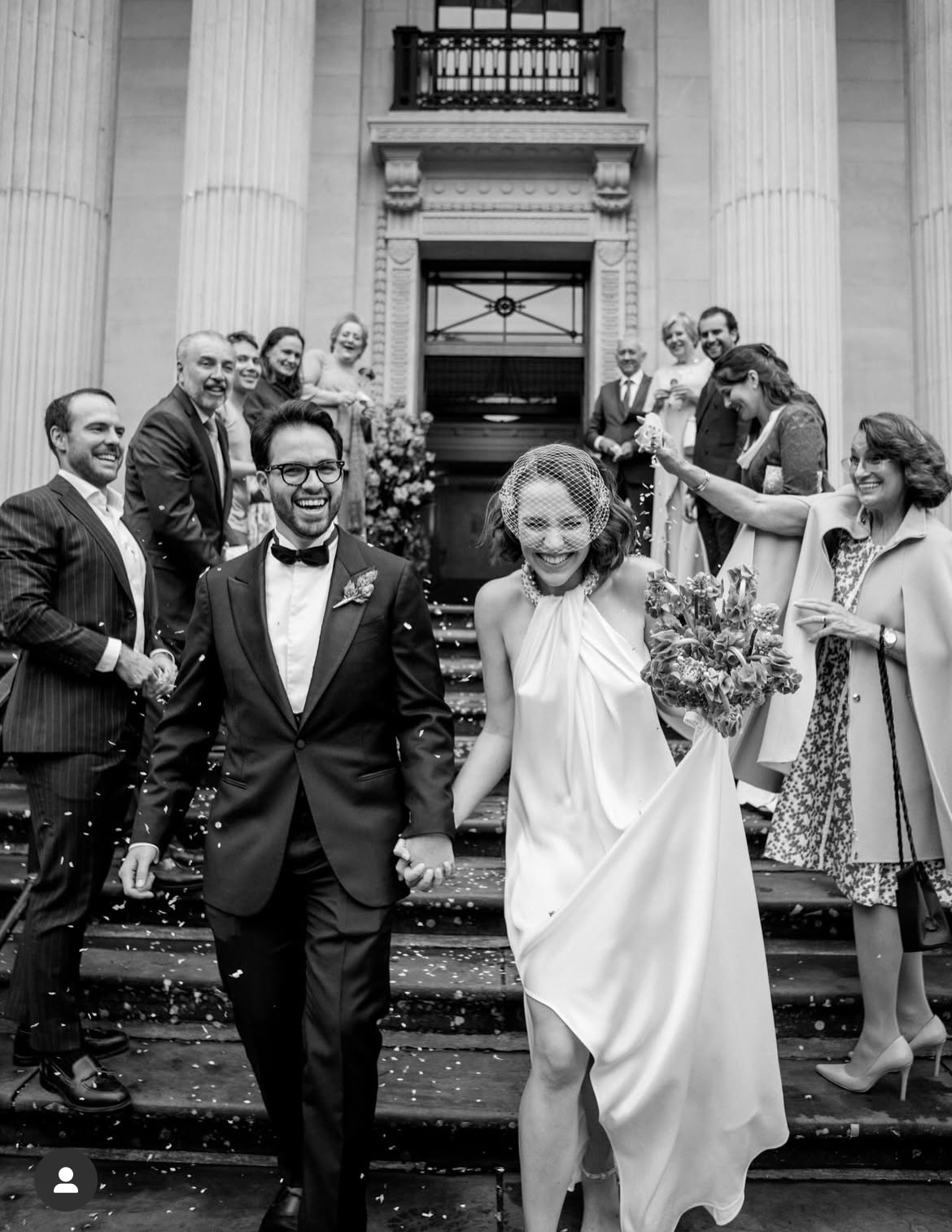 Bride and groom leaving a ceremony as guests throw confetti; modern halter wedding dress with crystal collar