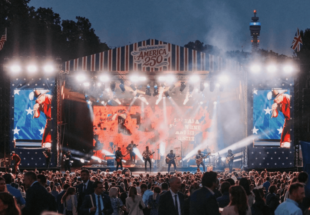Outdoor stage and crowd at the US Embassy gala celebrating America 250 in London